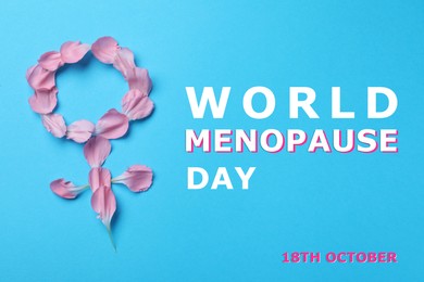 Image of World Menopause Day - October, 18. Female gender sign made of petals on light blue background, top view