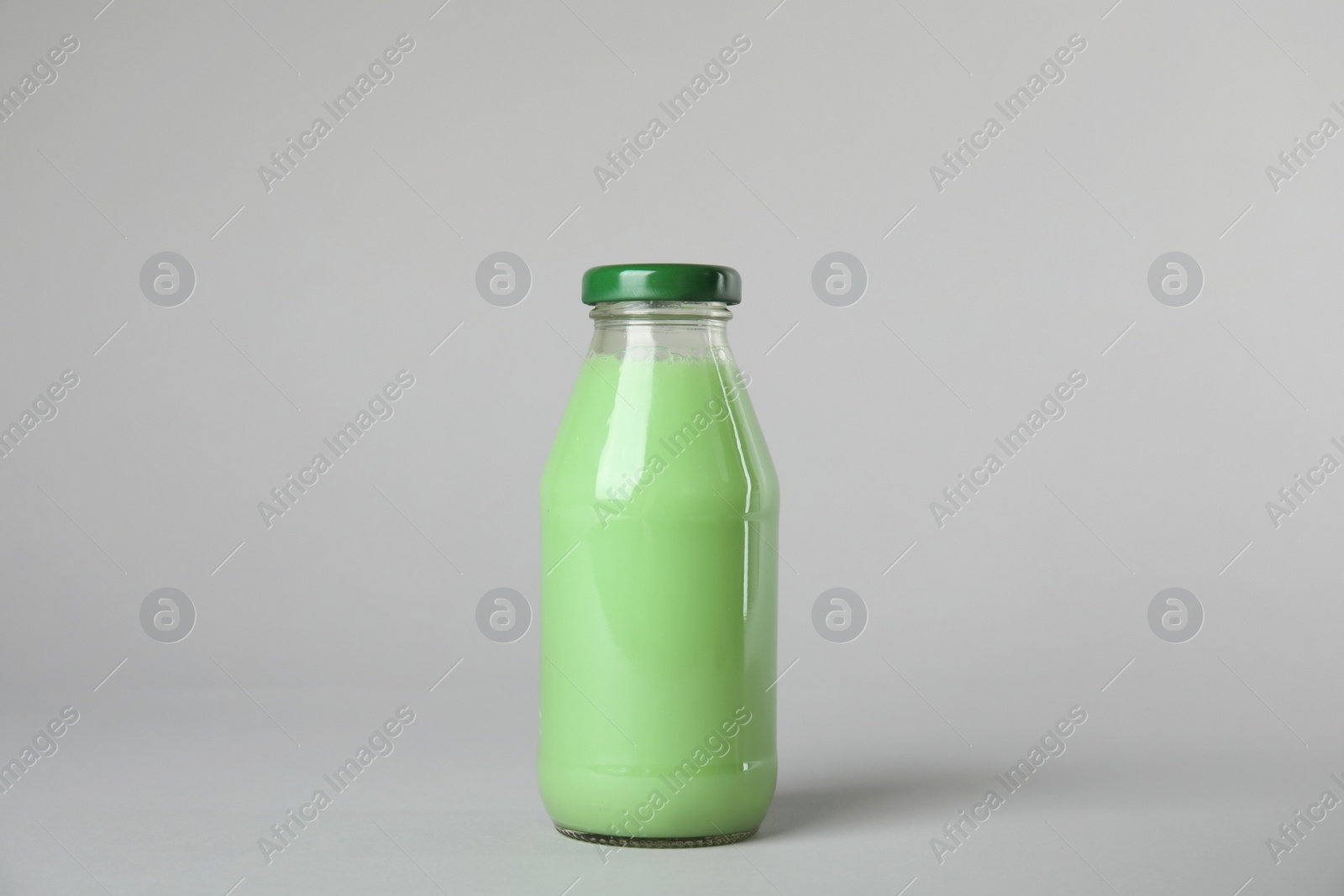 Photo of One bottle with tasty drink on color background