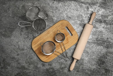 Photo of Set of cooking utensils on grey table, flat lay