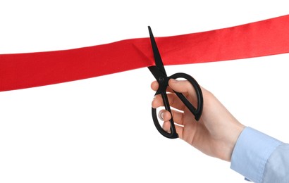 Man cutting red ribbon on white background, closeup