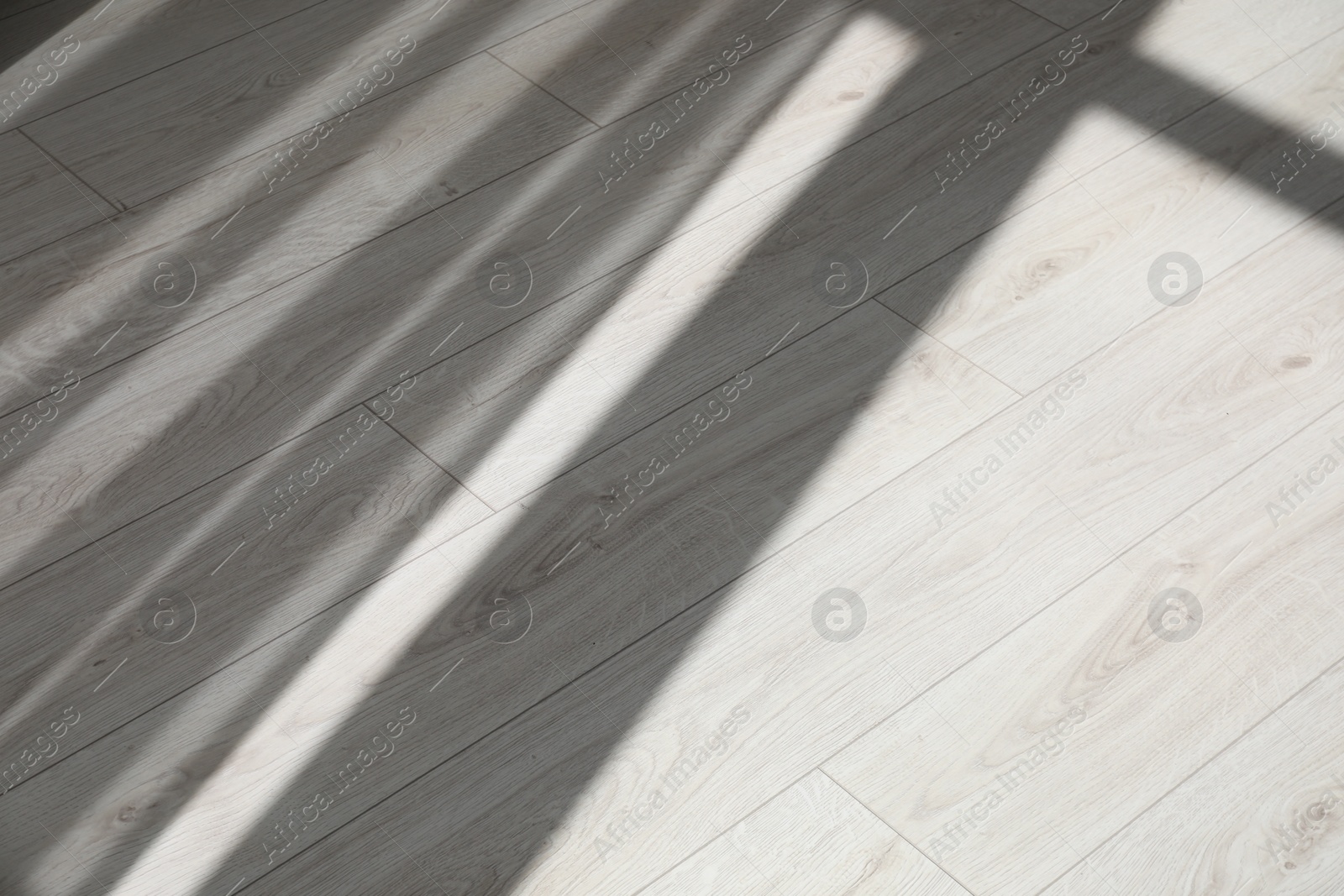 Photo of Shadow from window and curtains on white laminated floor