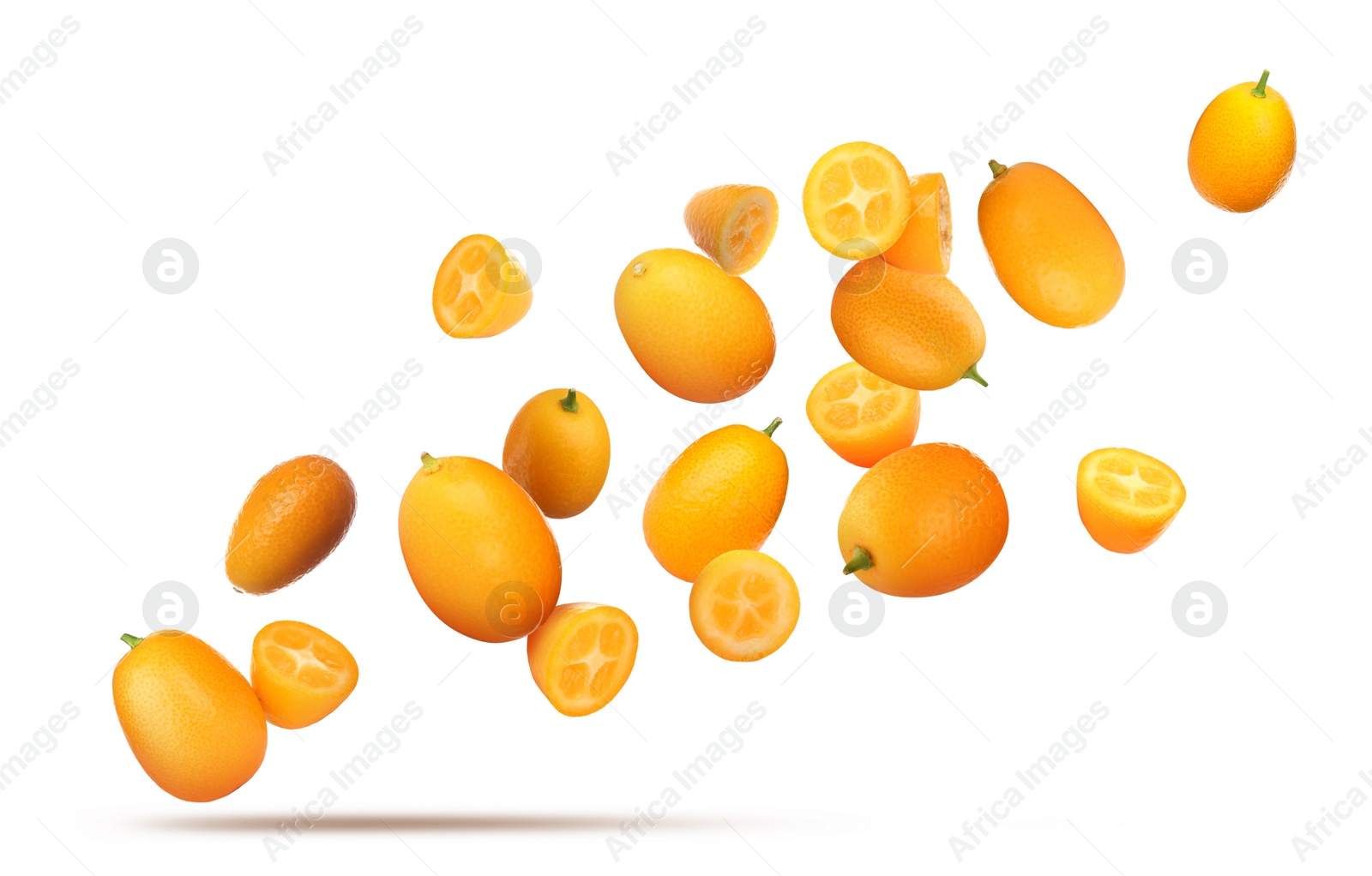 Image of Delicious whole and cut kumquats falling on white background