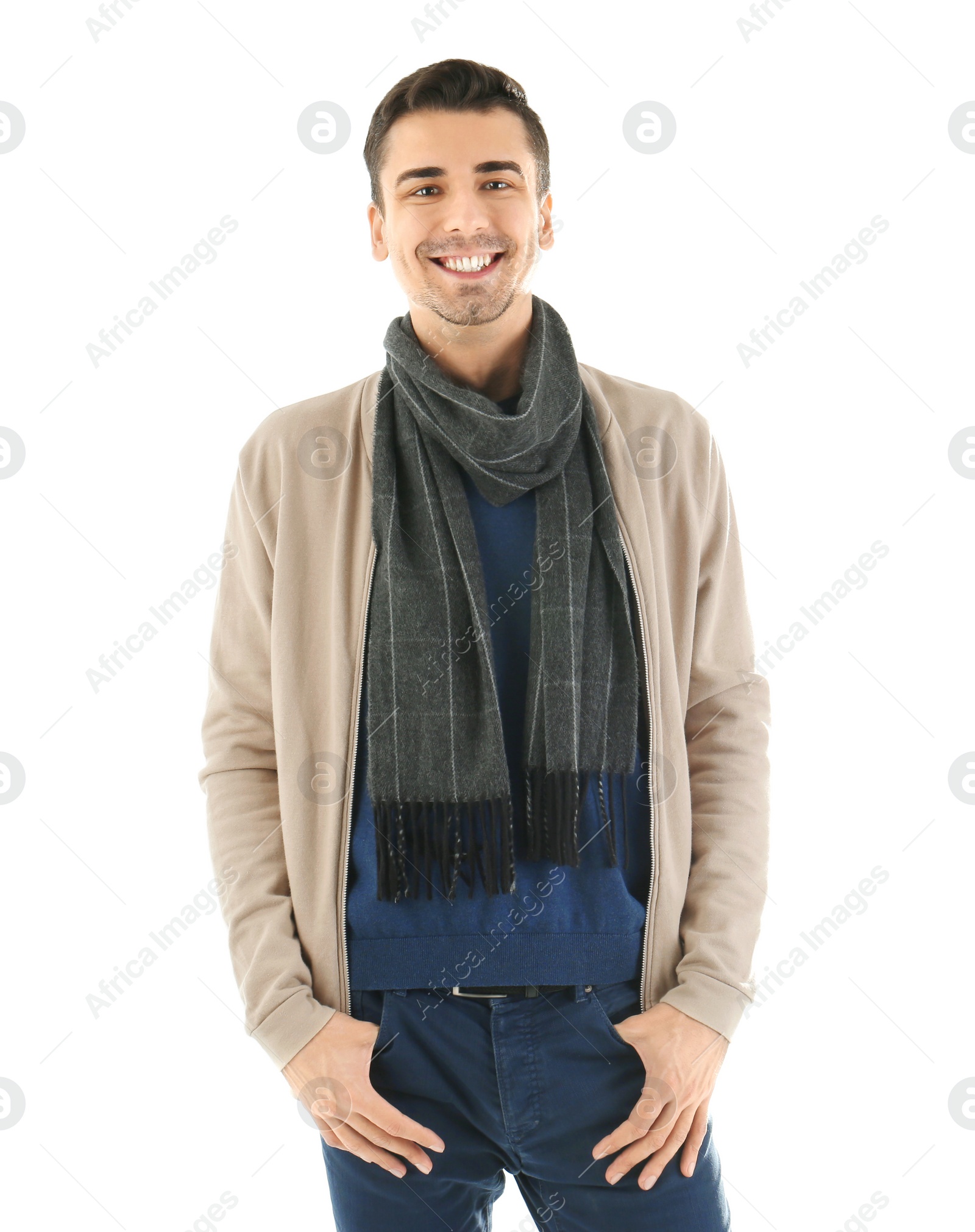 Photo of Portrait of happy young man in warm clothing on white background. Ready for winter vacation