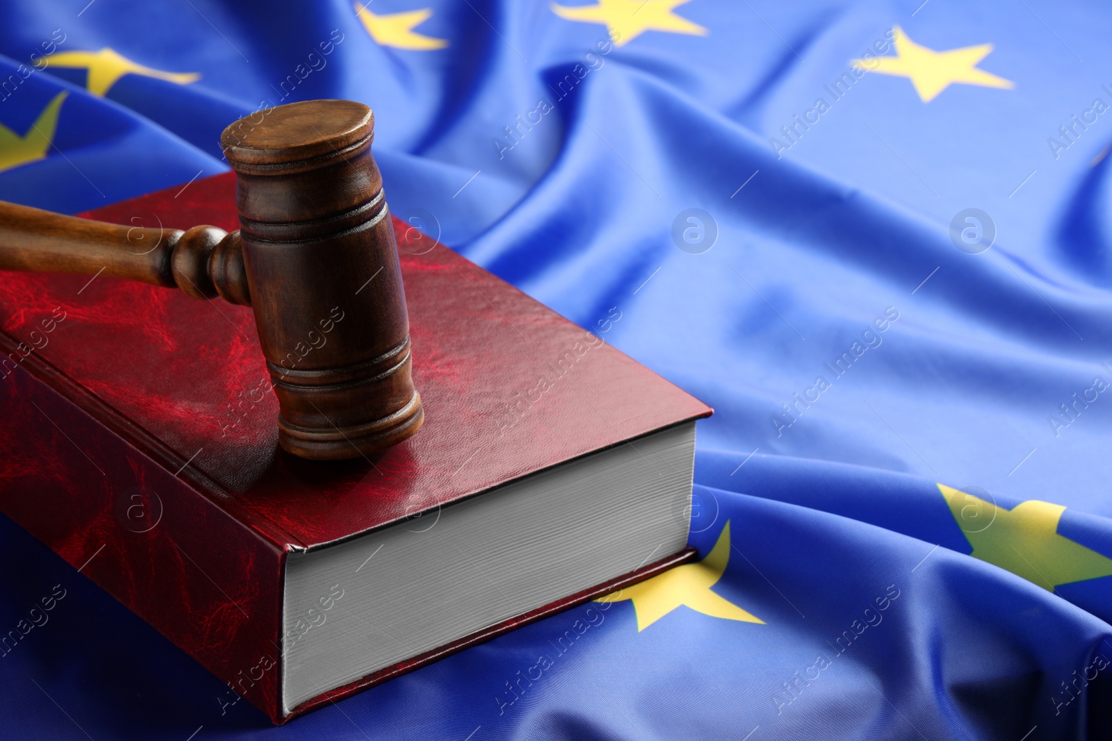 Photo of Wooden judge's gavel and book on flag of European Union, space for text