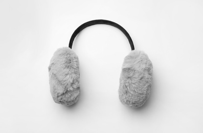 Stylish winter earmuffs on white background, top view