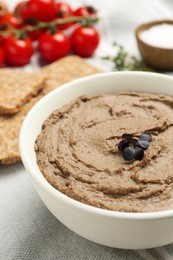 Photo of Tasty liver pate with herb in bowl on table, closeup