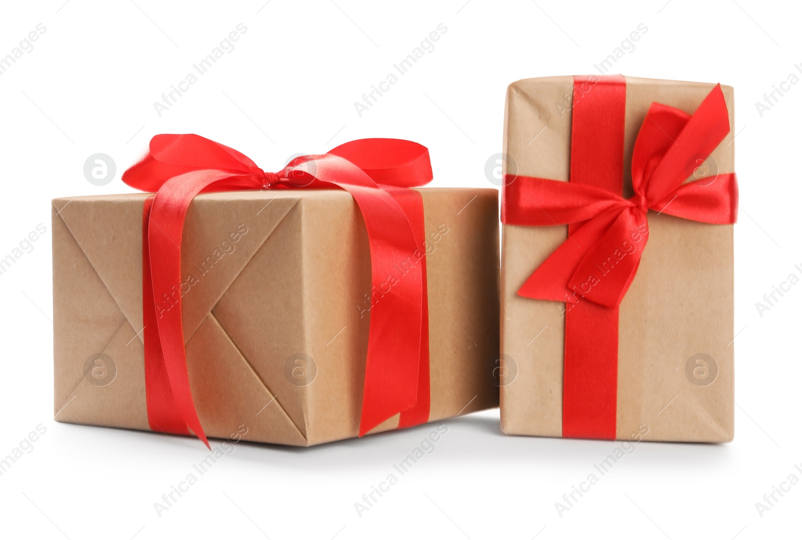 Photo of Christmas gift boxes decorated with red bows on white background