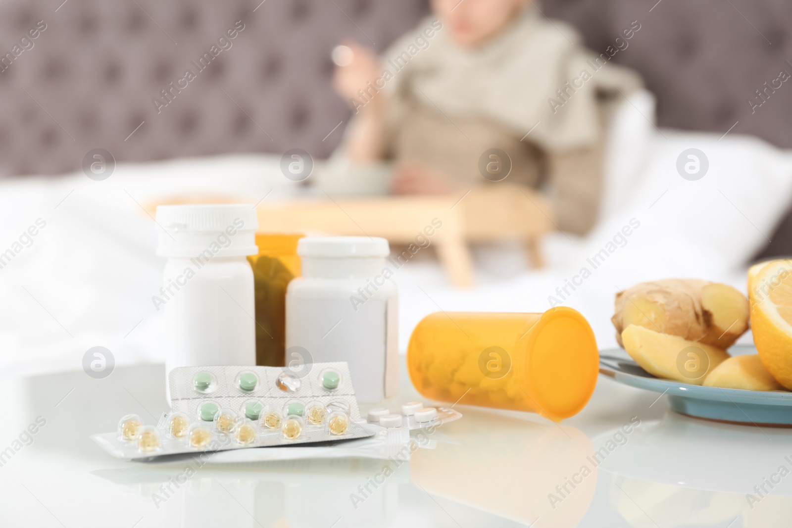 Photo of Cold medicine and sick woman on background