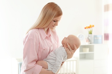 Happy mother and her baby at home