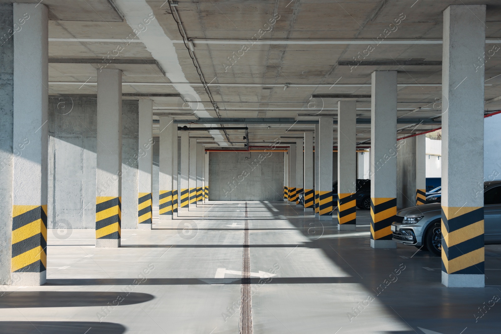 Photo of Open parking garage with cars on sunny day