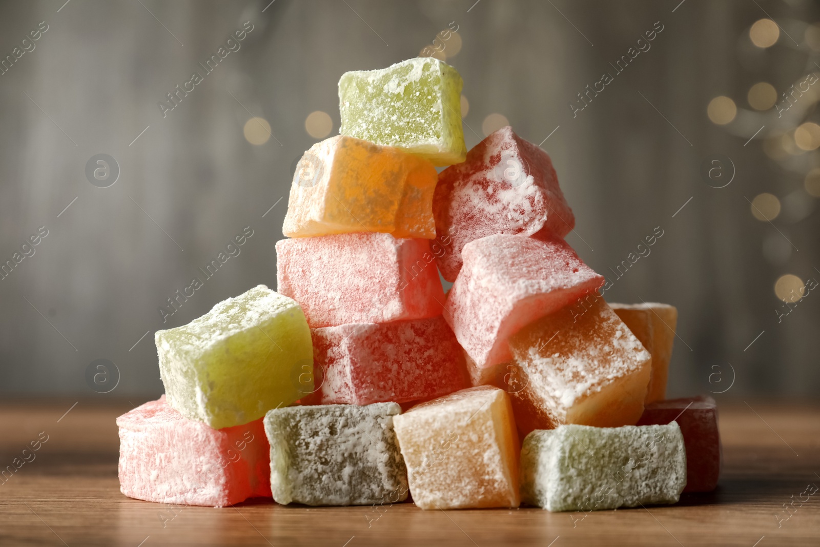 Photo of Turkish delight dessert on wooden table, closeup