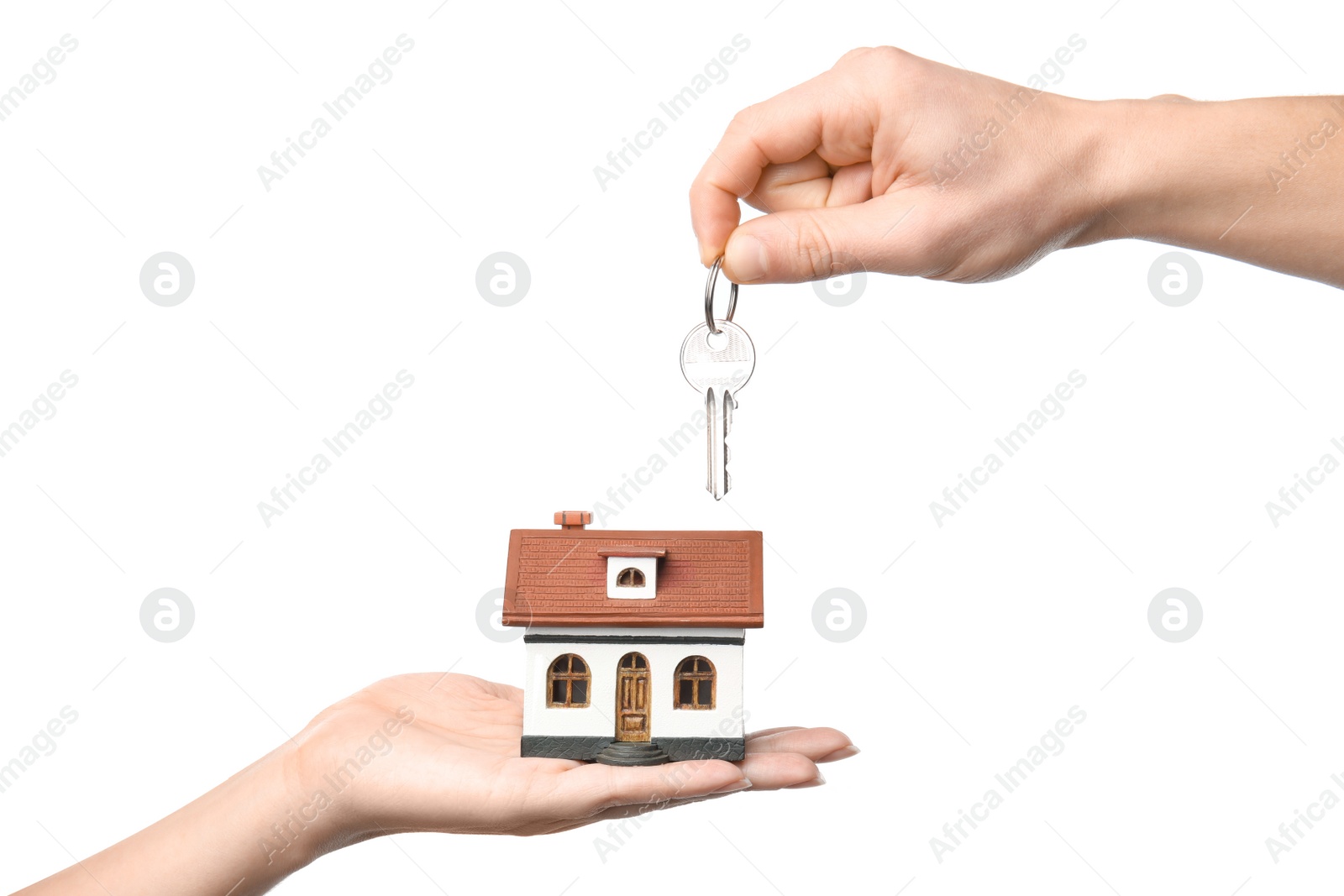 Photo of People holding key and house model on white background, closeup