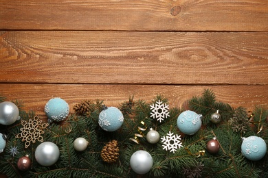 Flat lay composition with Christmas decorations on wooden background, space for text. Winter season