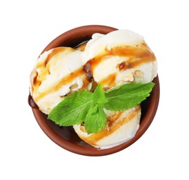 Photo of Tasty ice cream with caramel sauce, mint and nuts in bowl isolated on white, top view