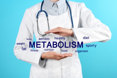 Image of Metabolism concept. Doctor presenting scheme on blue background, closeup