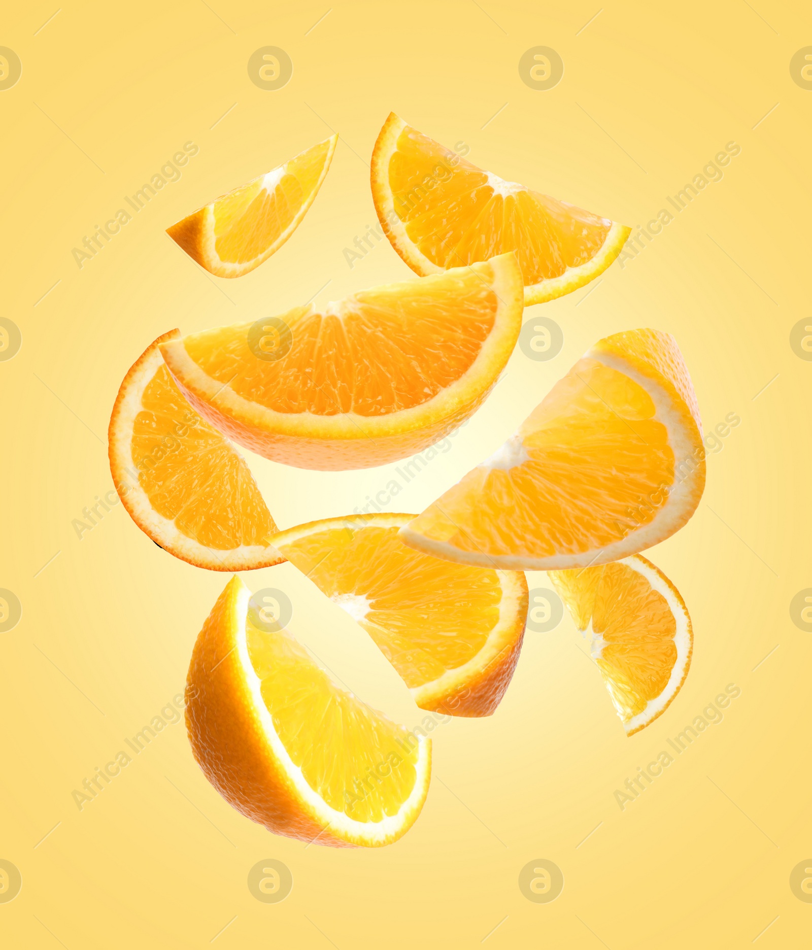 Image of Juicy orange slices flying on pale golden background