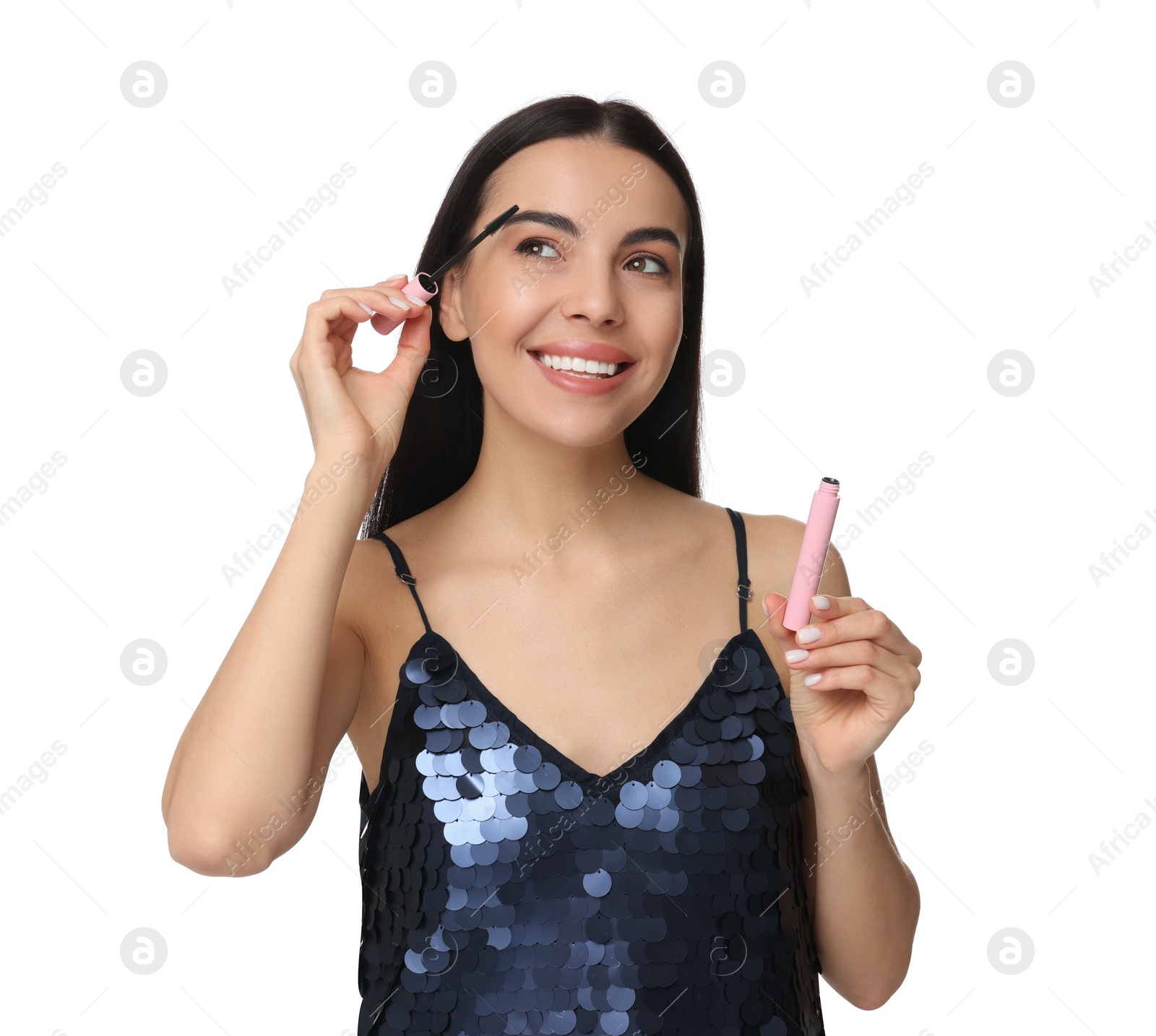 Photo of Beautiful young woman applying mascara on white background