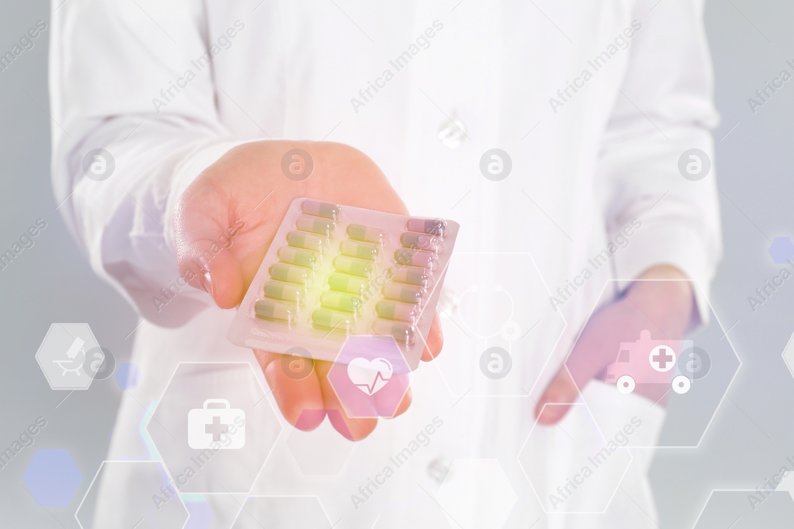 Image of Professional pharmacist with pills on grey background, closeup