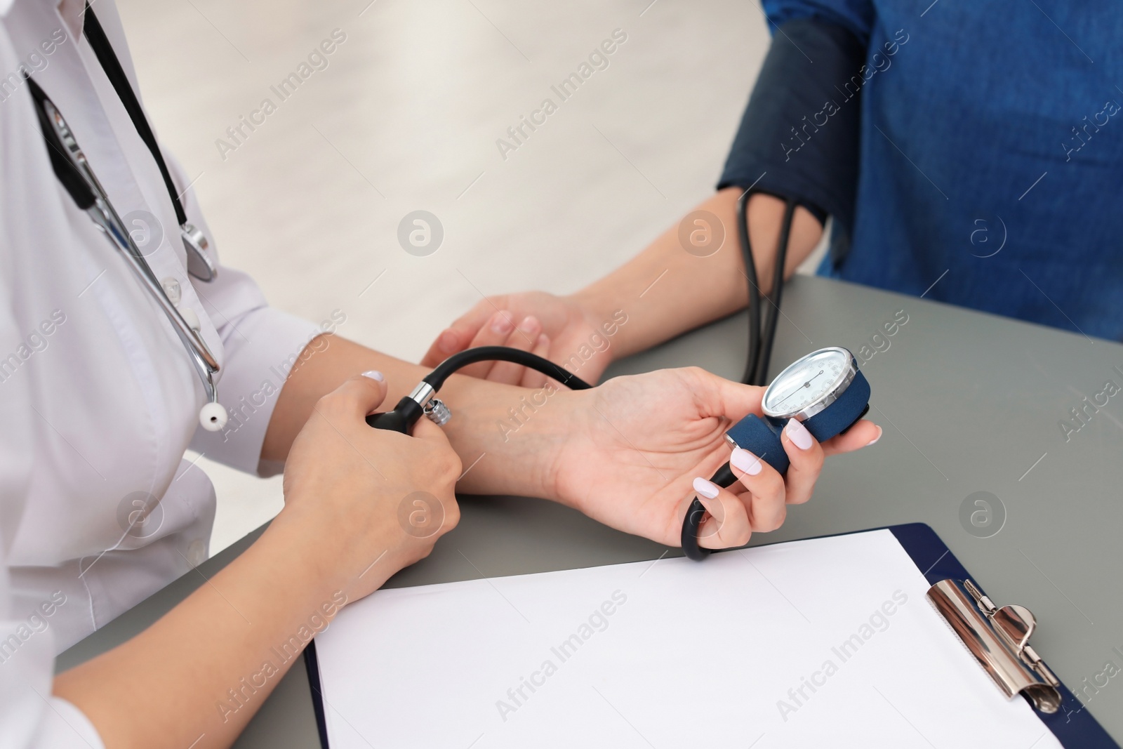 Photo of Doctor checking patient's blood pressure in hospital