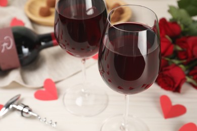 Glasses of red wine on white table, closeup