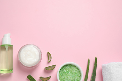 Photo of Flat lay composition with aloe vera and cosmetic products on pink background. Space for text