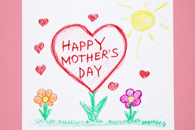 Photo of Handmade greeting card for Mother's Day on pink background, top view
