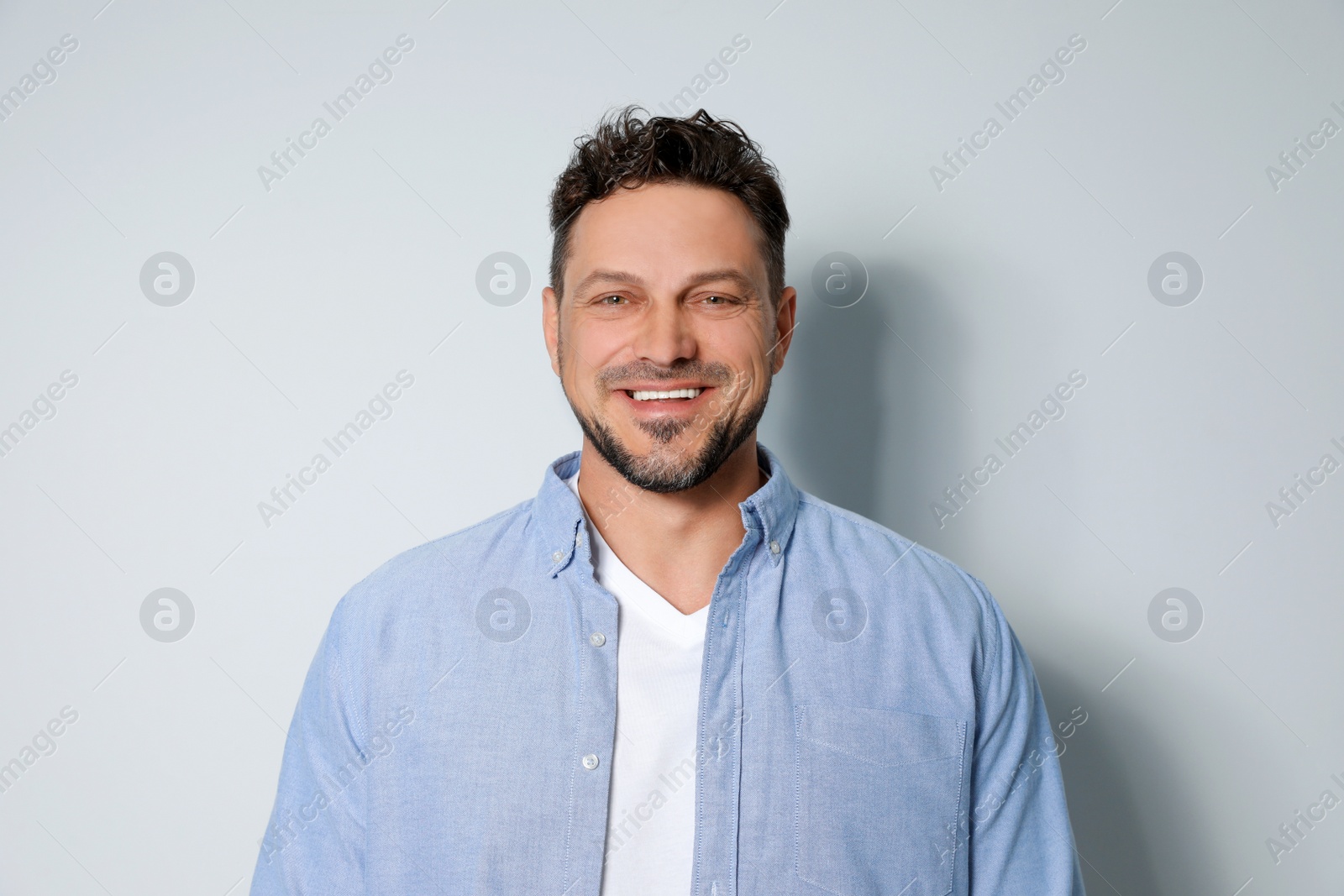 Photo of Portrait of handsome man on light grey background