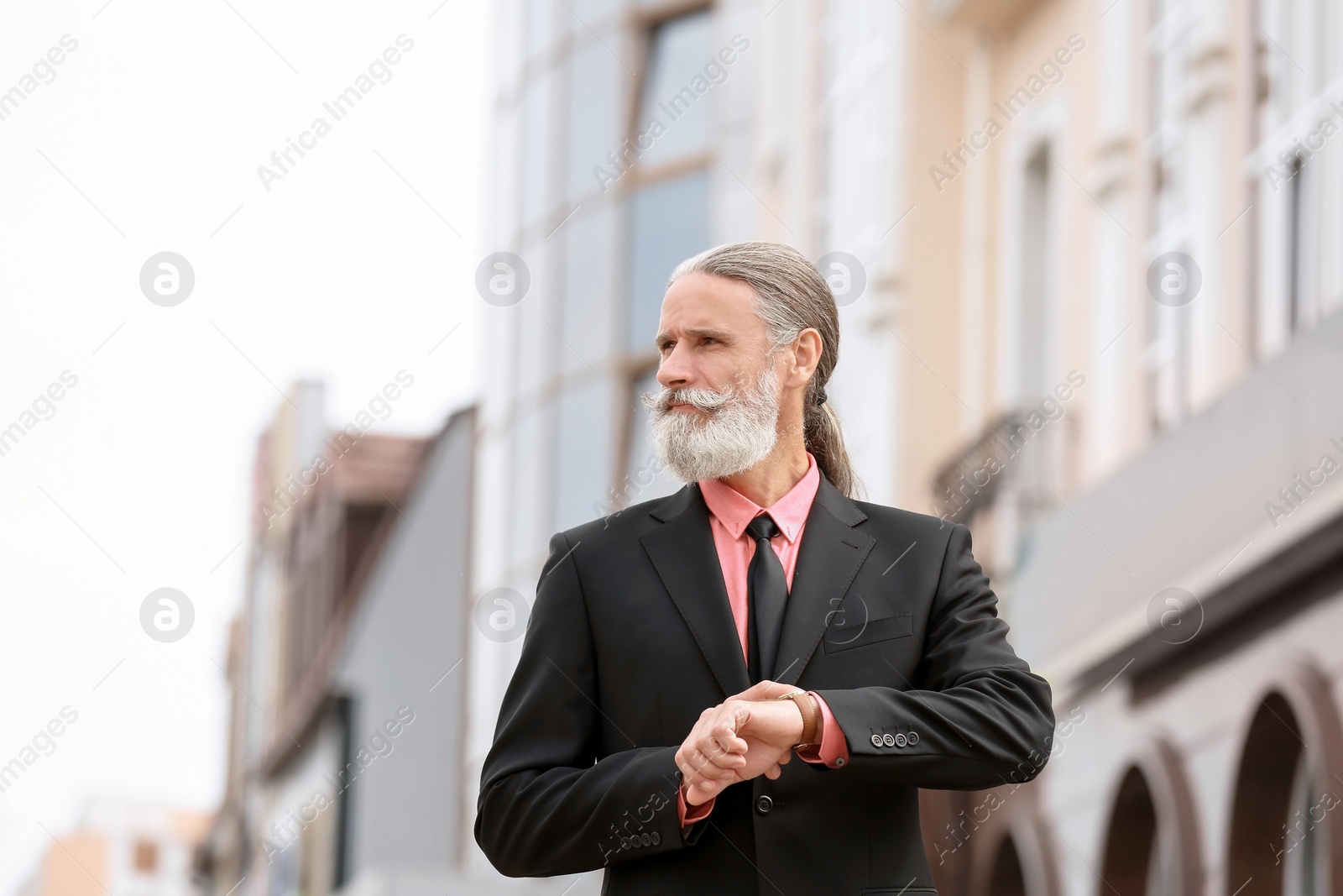 Photo of Handsome bearded mature man in suit, outdoors