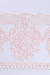 Photo of Beautiful lace on white background, top view