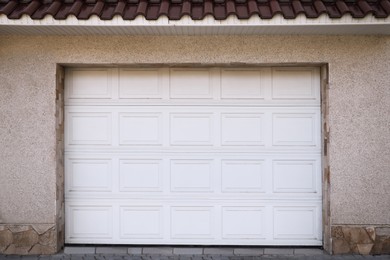 White modern sectional garage doors on building