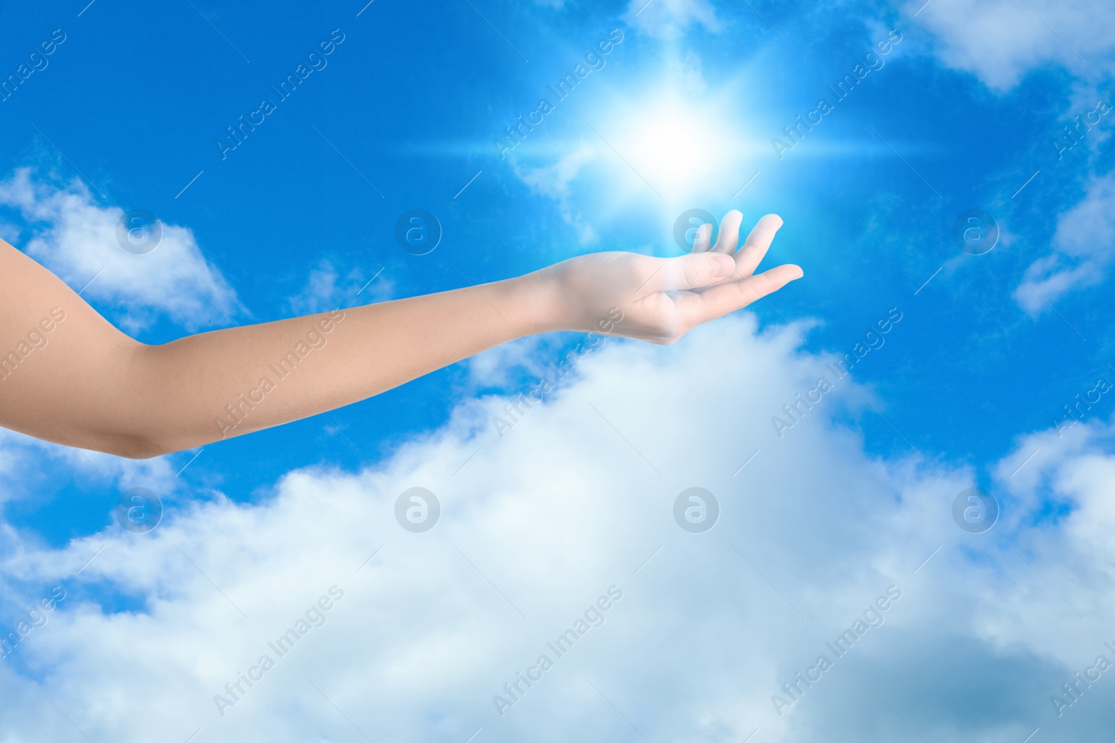 Image of Bright light in hand, closeup. Solar energy concept