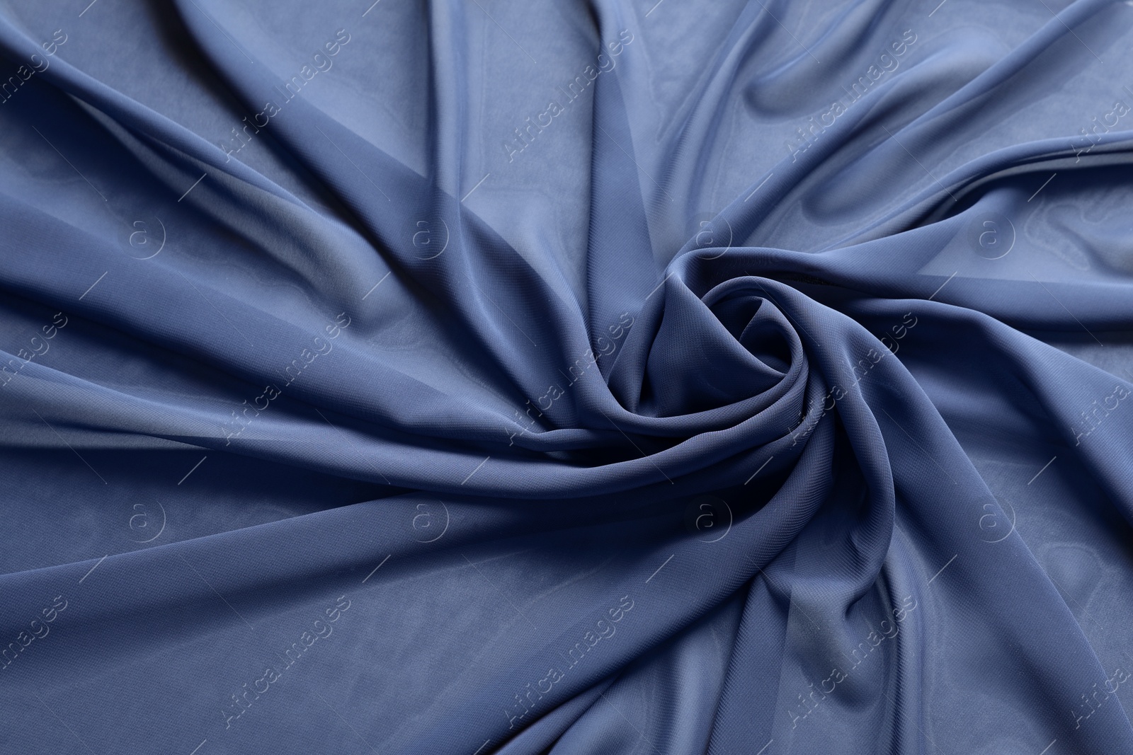 Photo of Beautiful dark blue tulle fabric as background, closeup