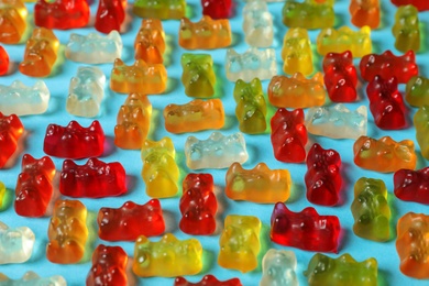 Photo of Flat lay composition with delicious jelly bears on color background