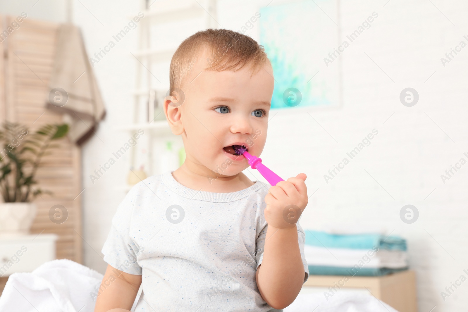 Photo of Cute little boy with toothbrush on blurred background