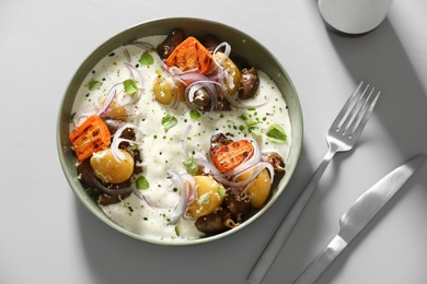 Photo of Tasty dish served on light table, flat lay