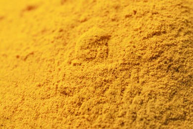 Photo of Aromatic turmeric powder on table, closeup view