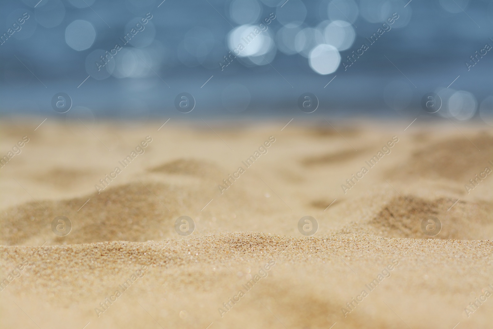 Photo of Sandy beach near sea on sunny day, closeup