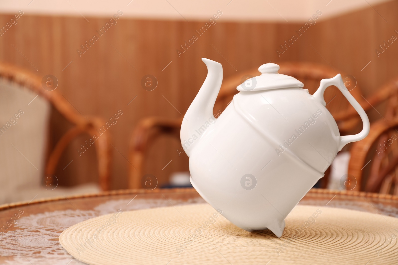 Photo of White teapot for traditional ceremony on table