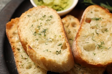 Tasty baguette with garlic and dill, closeup