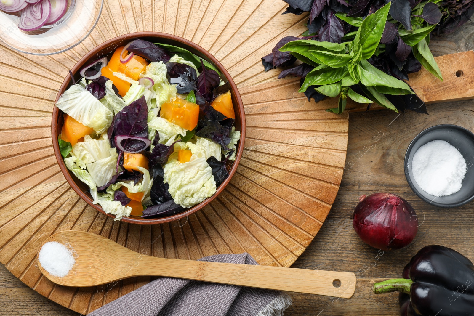 Photo of Delicious salad with Chinese cabbage, tomato and basil served on wooden table, flat lay