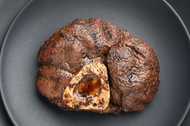 Photo of Piece of tasty grilled beef meat on plate, top view