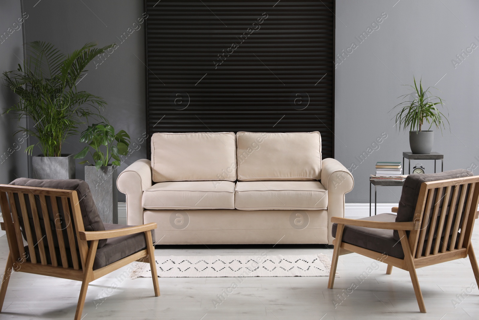Photo of Stylish living room interior with comfortable sofa and armchairs