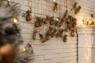 Photo of New Year advent calendar hanging on write brick wall indoors