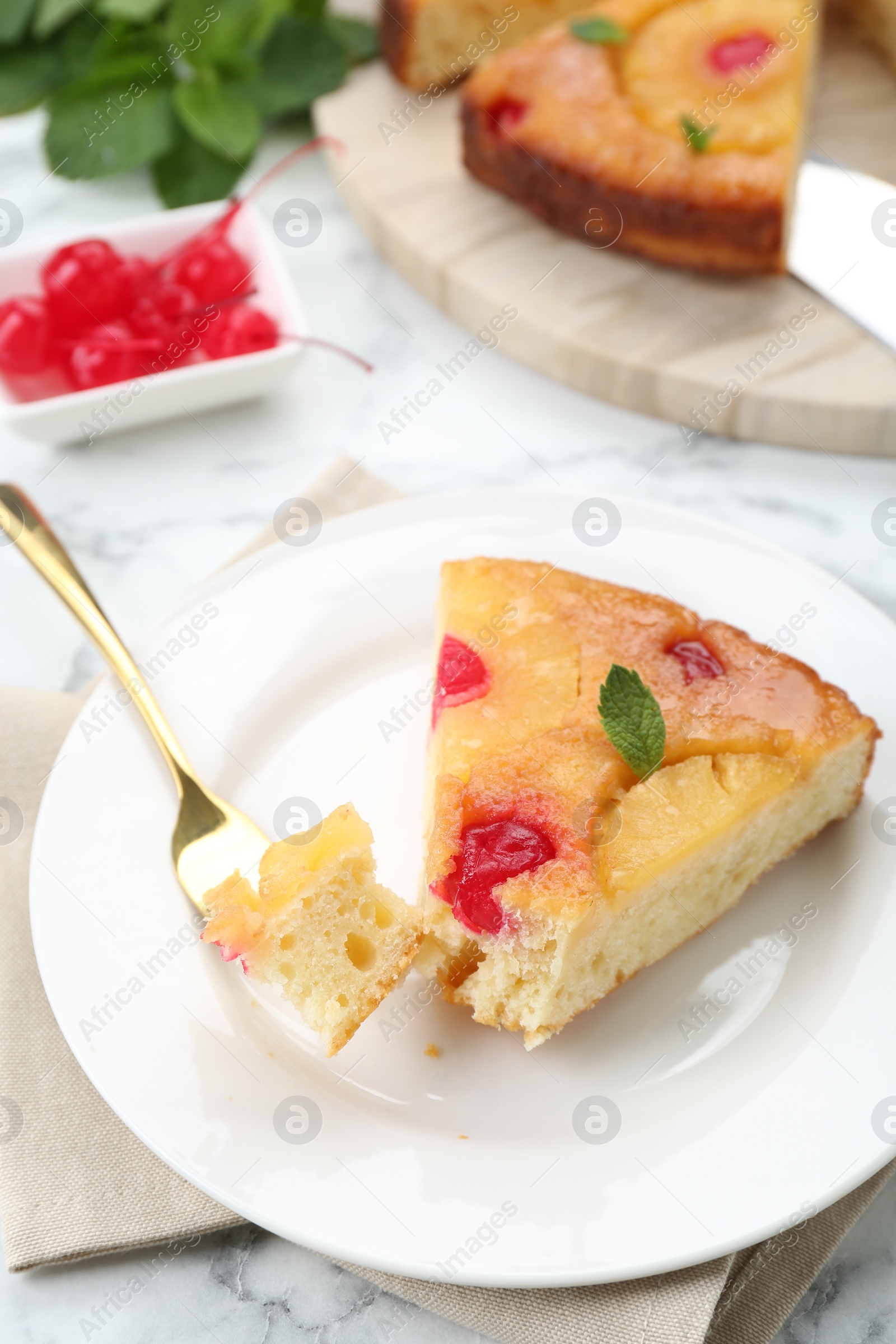 Photo of Eating piece of delicious pineapple pie with cherry and mint on white marble table