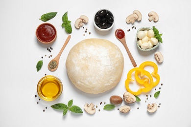 Flat lay composition with fresh ingredients for pizza on white background