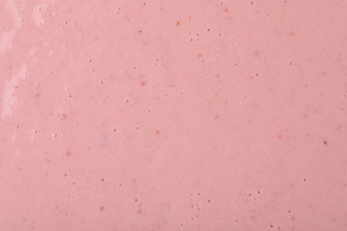 Photo of Tasty pink smoothie with bubbles as background, closeup