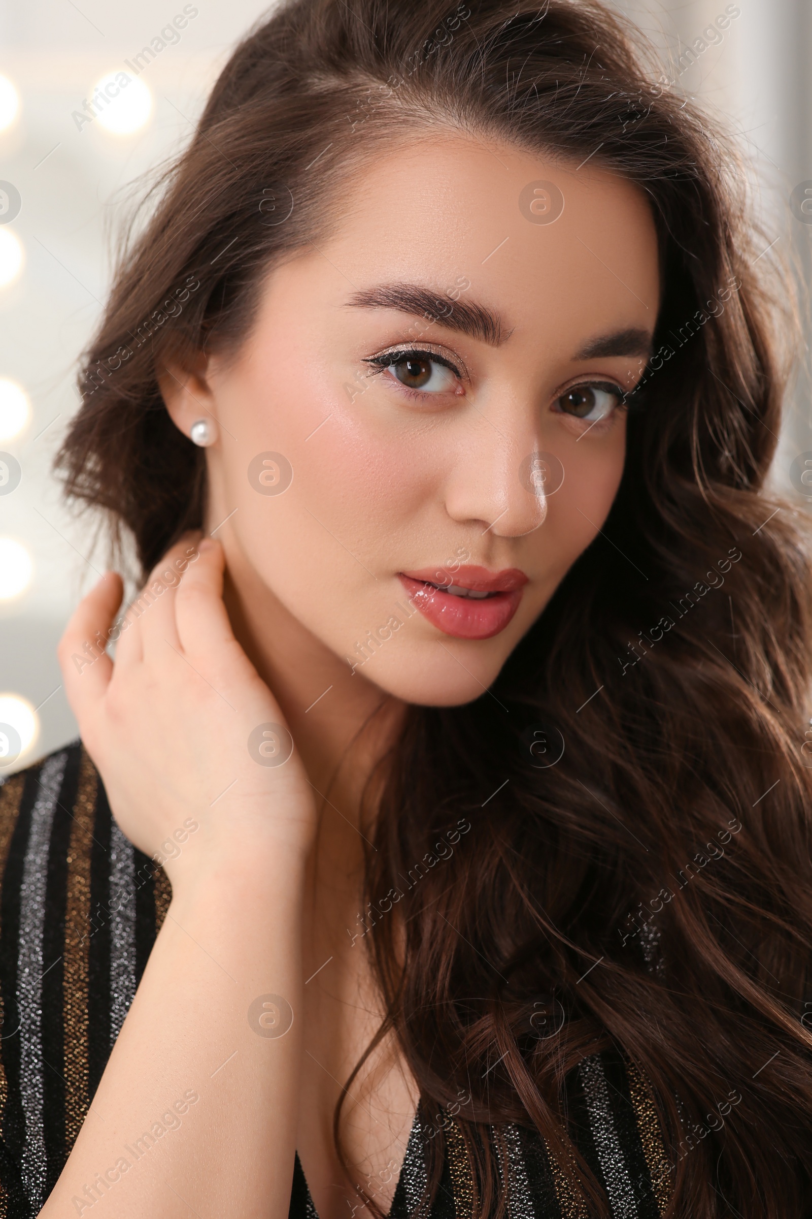 Photo of Portrait of beautiful young woman with wavy brown hair indoors