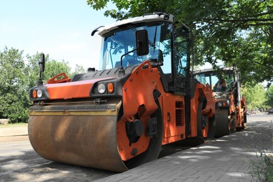 Photo of Modern rollers on city street. Road repair service