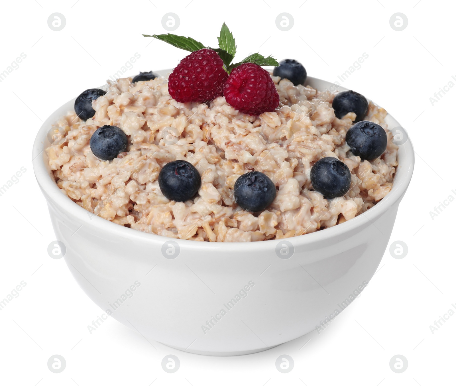 Photo of Tasty boiled oatmeal with berries in bowl isolated on white