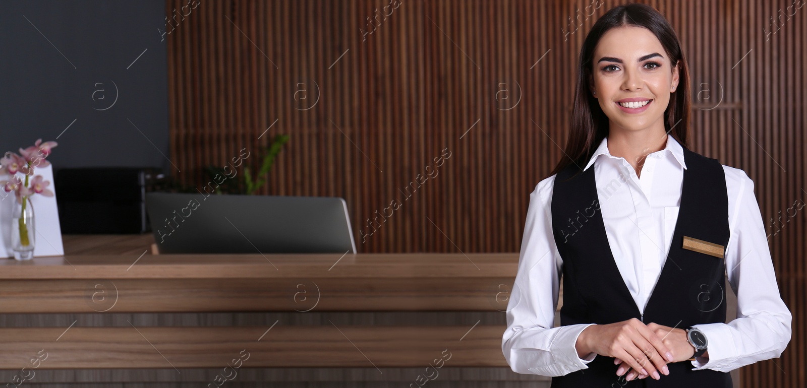 Image of Portrait of receptionist at desk in lobby. Banner design